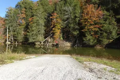 a road next to a body of water with trees at Timber Ridge Cabin in Louisa