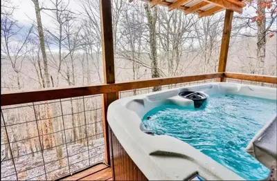 a jacuzzi tub on a screened in porch at Timber Ridge Cabin in Louisa
