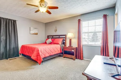 a bedroom with a bed and a ceiling fan at Castlerea Casa! Columbus Area Home with Yard in Hilliard
