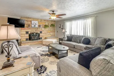a living room with a couch and a fireplace at half Mi to Kanawha River Quiet Escape with Patio in Chesapeake