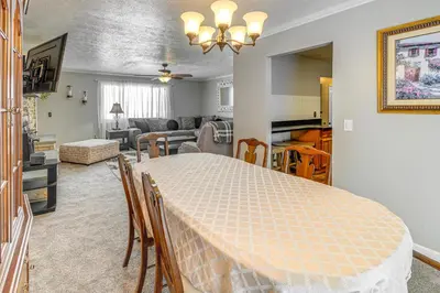 a dining room and living room with a table at half Mi to Kanawha River Quiet Escape with Patio in Chesapeake