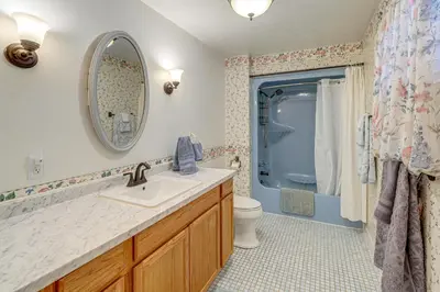 a bathroom with a sink and a toilet and a mirror at half Mi to Kanawha River Quiet Escape with Patio in Chesapeake