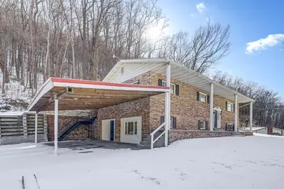 a brick building with a roof in the snow at half Mi to Kanawha River Quiet Escape with Patio in Chesapeake