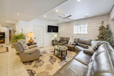 a living room with leather furniture and a christmas tree at Pool Table and Private Porch Peaceful Apt in Belle in Chesapeake