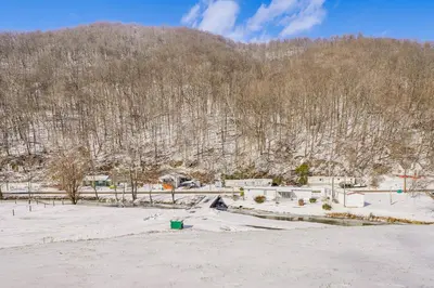 a snow covered field with a mountain in the background at Pool Table and Private Porch Peaceful Apt in Belle in Chesapeake
