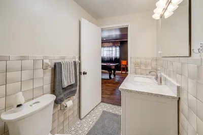 a white bathroom with a sink and a toilet at Pool Table and Private Porch Peaceful Apt in Belle in Chesapeake