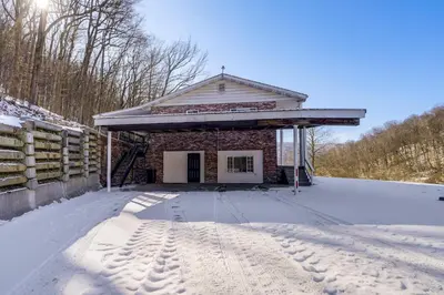 a building in the snow with footprints in the snow at Pool Table and Private Porch Peaceful Apt in Belle in Chesapeake
