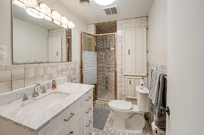 a bathroom with a sink and a toilet and a mirror at Pool Table and Private Porch Peaceful Apt in Belle in Chesapeake