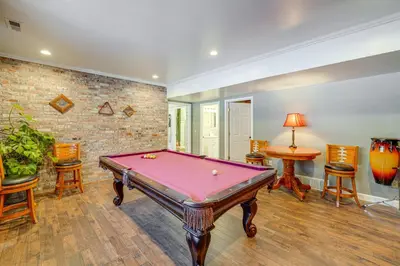 a pool table in a room with a brick wall at Pool Table and Private Porch Peaceful Apt in Belle in Chesapeake