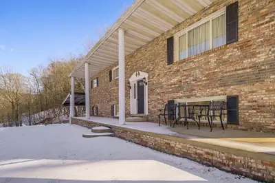 a brick building with a table and chairs on a patio at Pool Table and Private Porch Peaceful Apt in Belle in Chesapeake