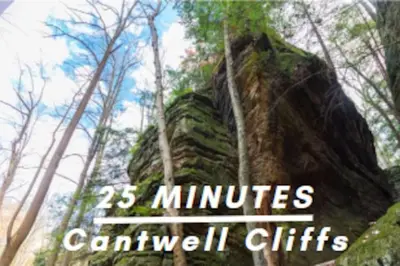 a rock in a forest with the words miracles carwell gifts at Romantic Logan Cabin with Private Year Round Hot Tub Near Hocking Hills in Logan