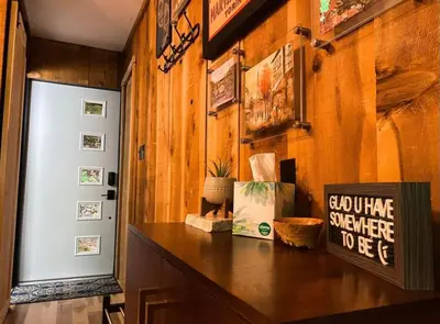 a hallway with a table with a sign on it at Hillside Haven Treehouse Cabin in Rockbridge