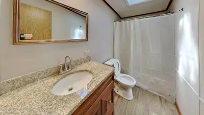 a bathroom with a sink and a toilet and a mirror at Put-in-Bay Island Club #12 in Put-in-Bay