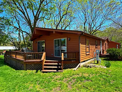 a small cabin with a porch and a deck at Put-in-Bay Island Club #12 in Put-in-Bay