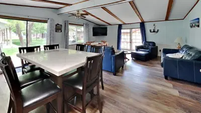 a dining room and living room with a table and chairs at Put-in-Bay Island Club #63 in Put-in-Bay