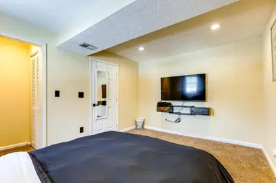 a bedroom with a bed and a tv on the wall at Shop, Dine and Play Cincinnati Retreat! in Cincinnati