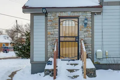 a door on a house in the snow at Shop, Dine and Play Cincinnati Retreat! in Cincinnati