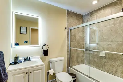 a bathroom with a shower and a toilet and a sink at Shop, Dine and Play Cincinnati Retreat! in Cincinnati