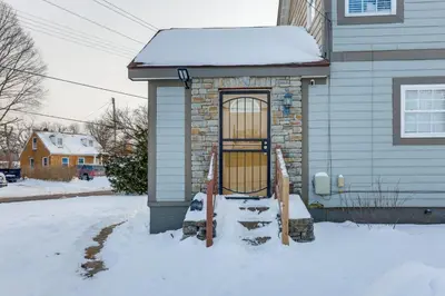 a door on a house in the snow at Shop, Dine and Play Cincinnati Retreat! in Cincinnati