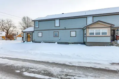 a gray house with snow in front of it at Shop, Dine and Play Cincinnati Retreat! in Cincinnati