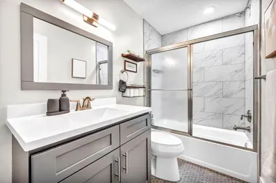 a bathroom with a sink and a shower and a toilet at The Pearl Hideaway Cozy West Side Gem Near DT in Cleveland