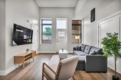 a living room with a couch and a tv at The Pearl Hideaway Cozy West Side Gem Near DT in Cleveland