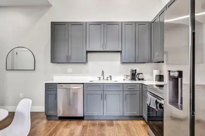 a kitchen with gray cabinets and a sink at The Pearl Hideaway Cozy West Side Gem Near DT in Cleveland