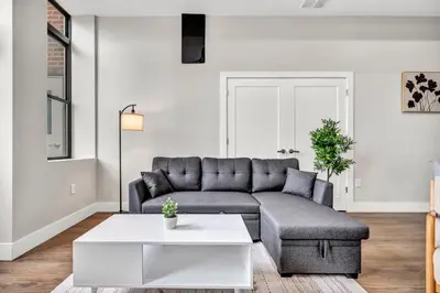 a living room with a couch and a table at The Pearl Hideaway Cozy West Side Gem Near DT in Cleveland