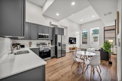 a kitchen and living room with a table and chairs at The Pearl Hideaway Cozy West Side Gem Near DT in Cleveland
