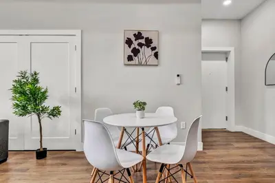 a white dining room with a white table and chairs at The Pearl Hideaway Cozy West Side Gem Near DT in Cleveland