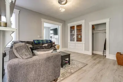 a living room with a couch and a table at Walk to Trolley District Olde Towne East Retreat in Columbus
