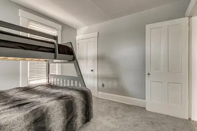 a bedroom with a bunk bed and a window at Walk to Trolley District Olde Towne East Retreat in Columbus