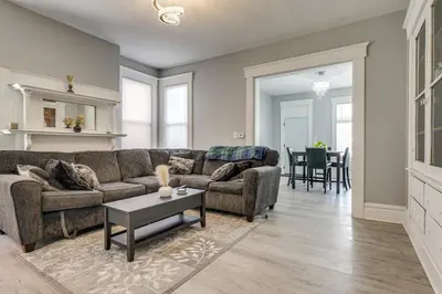 a living room with a couch and a table at Walk to Trolley District Olde Towne East Retreat in Columbus