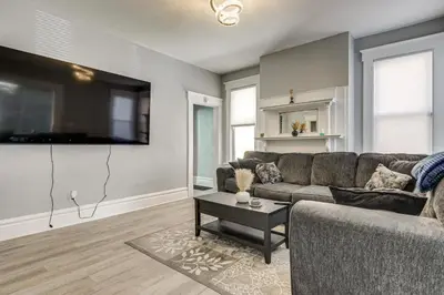 a living room with a couch and a table at Walk to Trolley District Olde Towne East Retreat in Columbus