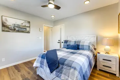 a bedroom with a bed with a blue and white comforter at Stay in the Heart of London! Walkable, Modern Home in London