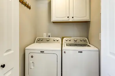 a small kitchen with two washers and a stove at Stay in the Heart of London! Walkable, Modern Home in London