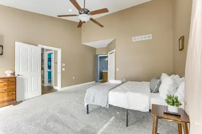 a bedroom with a bed and a ceiling fan at Family Home on 9 Acres! Climbing Wall and Gym in Thornville