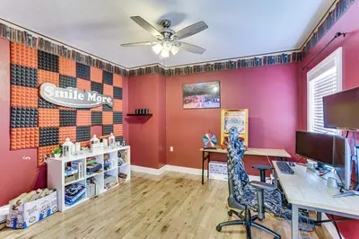 an office with pink walls and a desk with a computer at Family Home on 9 Acres! Climbing Wall and Gym in Thornville