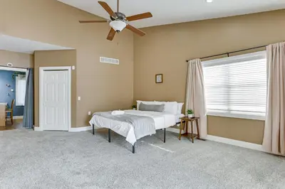 a bedroom with a bed and a ceiling fan at Family Home on 9 Acres! Climbing Wall and Gym in Thornville