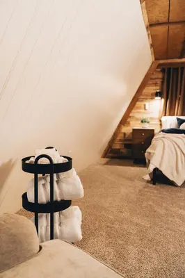 a room with a pile of towels in a attic at The Rustic Triangle A-Frame in Perrysville