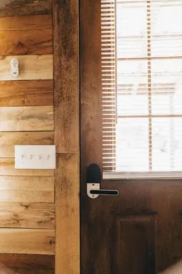 a door with a phone on it next to a window at The Rustic Triangle A-Frame in Perrysville