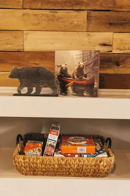 a shelf with a basket of food and a toy bear at The Rustic Triangle A-Frame in Perrysville