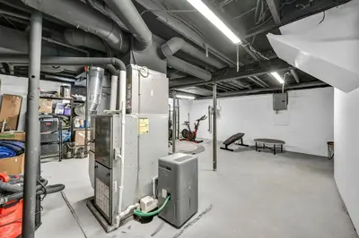 a large room with a workshop with machines at Modern Stylish Urban Haven 4 Bedroom 2 Bath - Dog Friendly in Akron