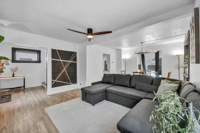 a living room with a couch and a ceiling fan at Modern Stylish Urban Haven 4 Bedroom 2 Bath - Dog Friendly in Akron