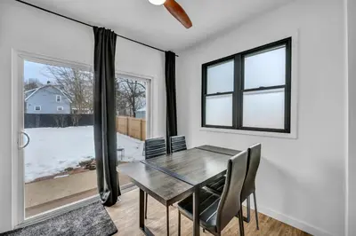 a dining room with a table and chairs and a window at Modern Stylish Urban Haven 4 Bedroom 2 Bath - Dog Friendly in Akron