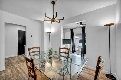 a dining room with a glass table and chairs at Modern Stylish Urban Haven 4 Bedroom 2 Bath - Dog Friendly in Akron
