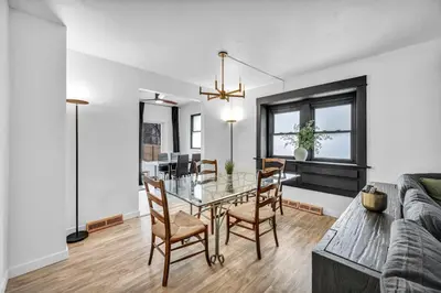 a dining room and living room with a table and chairs at Modern Stylish Urban Haven 4 Bedroom 2 Bath - Dog Friendly in Akron