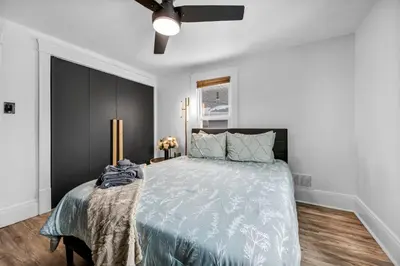 a bedroom with a bed and a ceiling fan at Modern Stylish Urban Haven 4 Bedroom 2 Bath - Dog Friendly in Akron