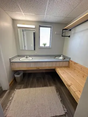 a bathroom with a sink and a mirror at Tecumseh Inn & Suites in Tecumseh