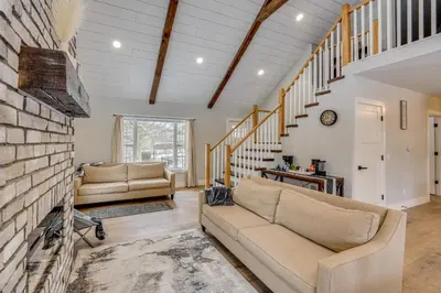 a living room with a couch and a brick wall at Willard Home On Working Farm with Water Views! in Willard